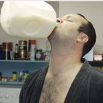 man in bathrobe chest hair showing drinks milk from a floating jug